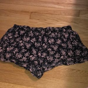 Black comfortable shorts that have pink flowers
